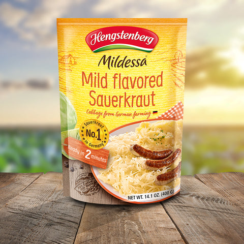 Hengstenberg Mildessa Mild Flavored Sauerkraut package on a wooden surface with a blurred outdoor background
